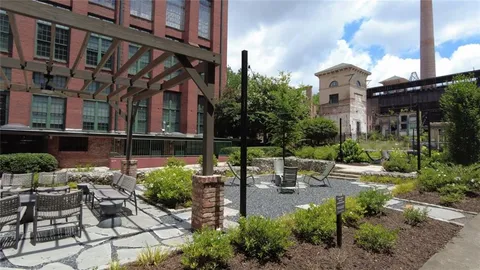 a view of a patio with table and chairs and potted plants