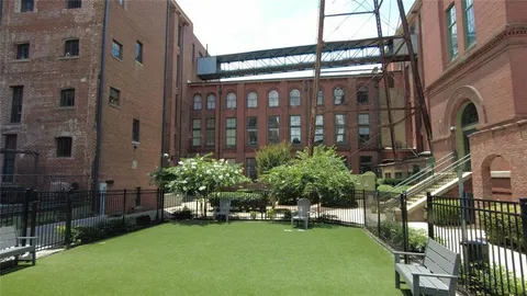 a view of a roof deck with two chairs and a table