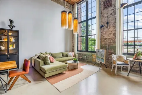 a living room with furniture and a potted plant