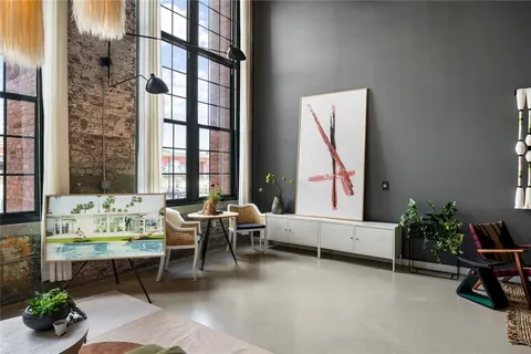 a living room with furniture and a potted plant