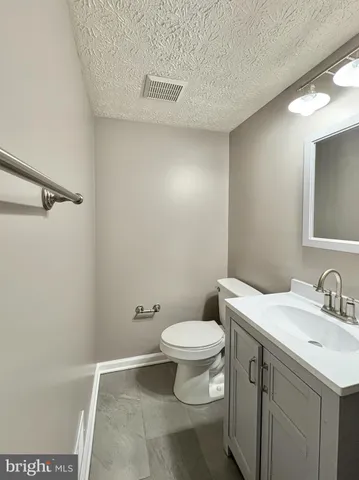 a bathroom with a sink toilet and a mirror