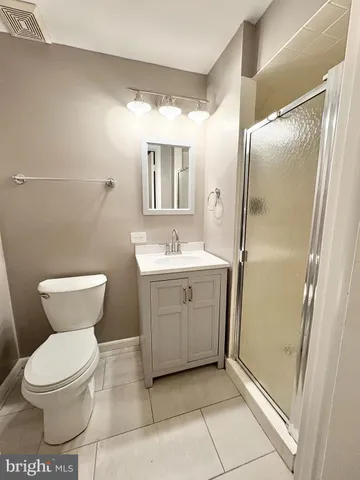 a bathroom with a toilet sink and a mirror
