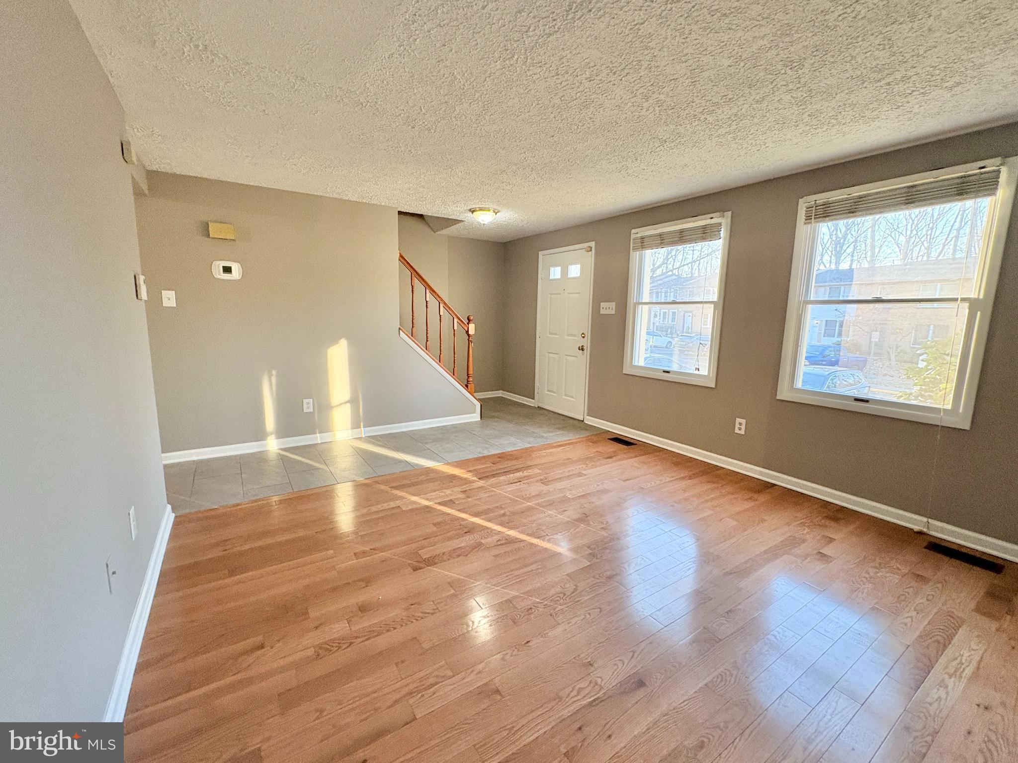 8263 Burning Forest Court Springfield, VA 22153 - Photo 3 of 43 an empty room with wooden floor and windows