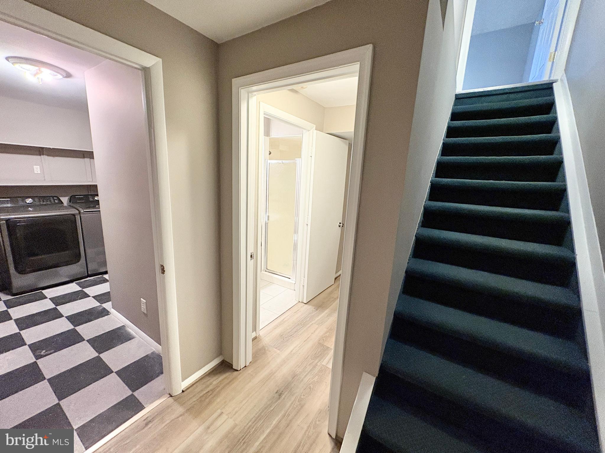 8263 Burning Forest Court Springfield, VA 22153 - Photo 31 of 43 a view of a hallway with wooden floor and white walls