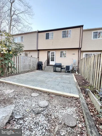 a view of a house with a wooden fence