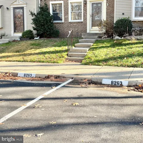 a view of a house with a yard potted plants