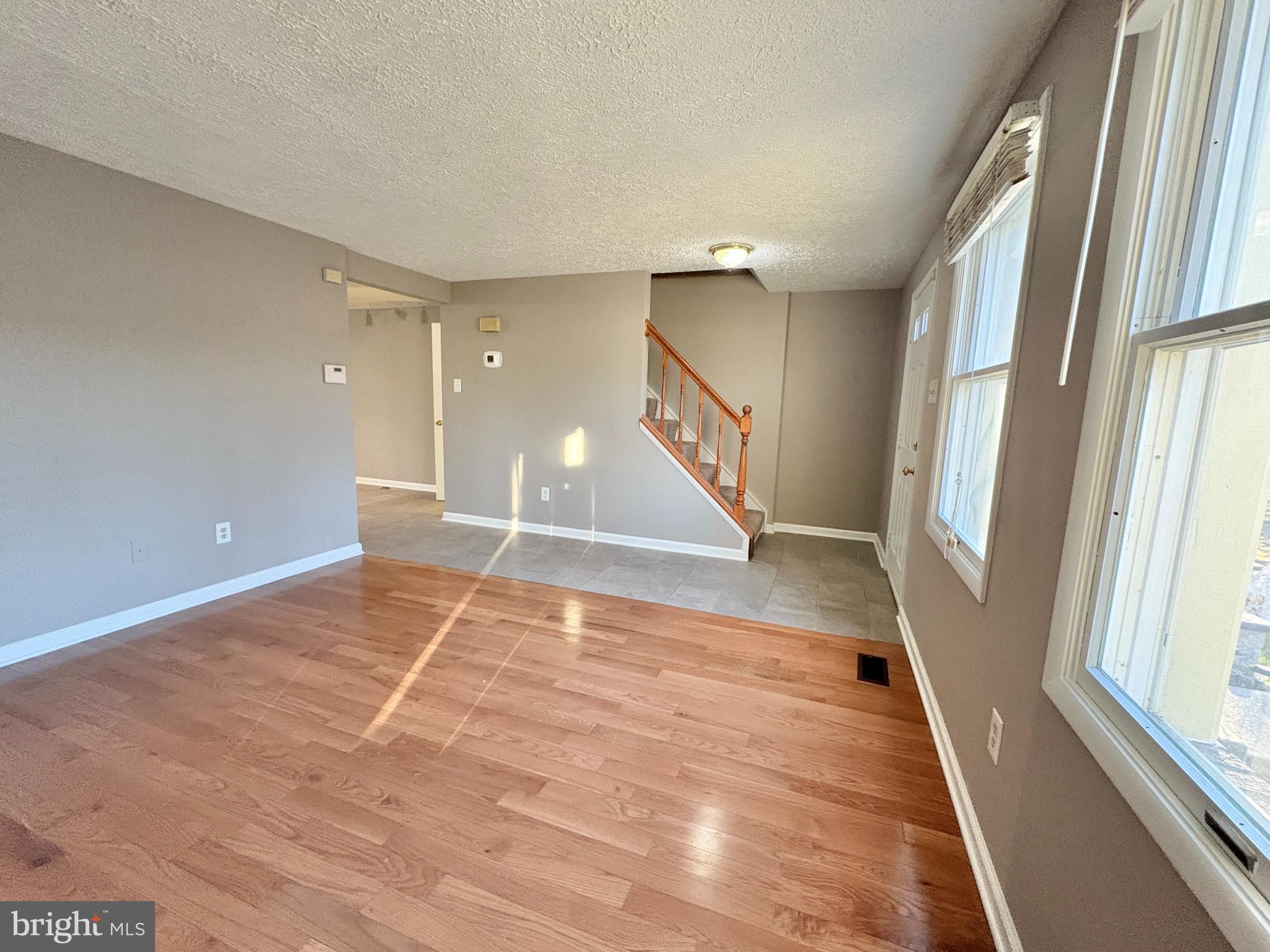 8263 Burning Forest Court Springfield, VA 22153 - Photo 9 of 43 a view of an empty room with wooden floor and a window