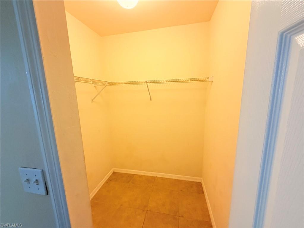 8397 Bahamas Road Fort Myers, FL 33967 - Photo 20 of 37 Walk in closet with light tile patterned flooring