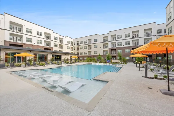 a swimming pool with outdoor seating and yard