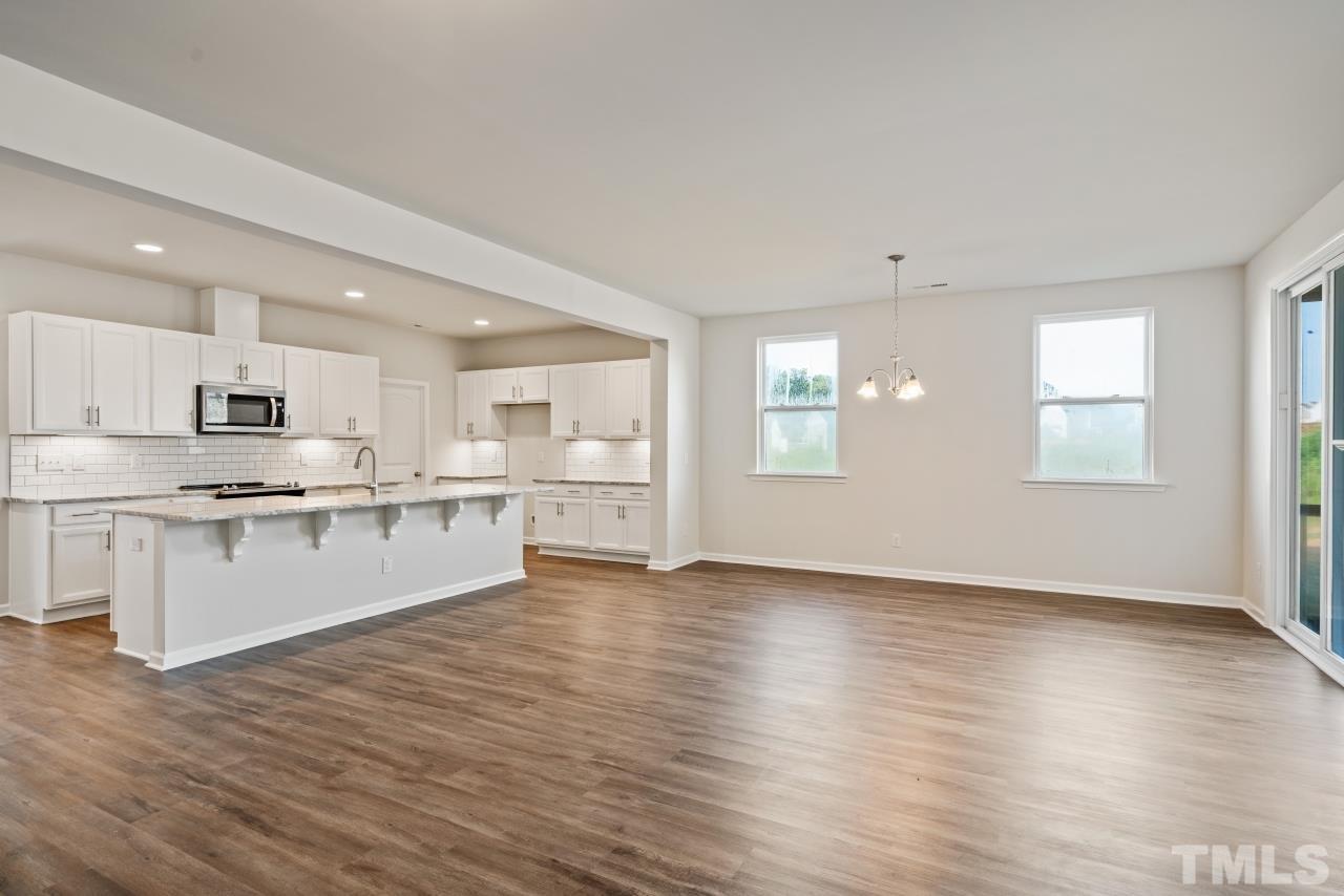 129 Scoville Road Garner, NC 27529 - Photo 13 of 25 a view of kitchen with wooden floor and electronic appliances
