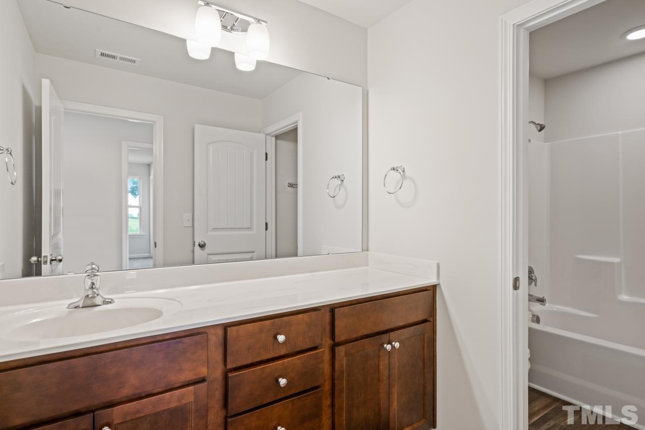 129 Scoville Road Garner, NC 27529 - Photo 14 of 25 a bathroom with a sink and a mirror