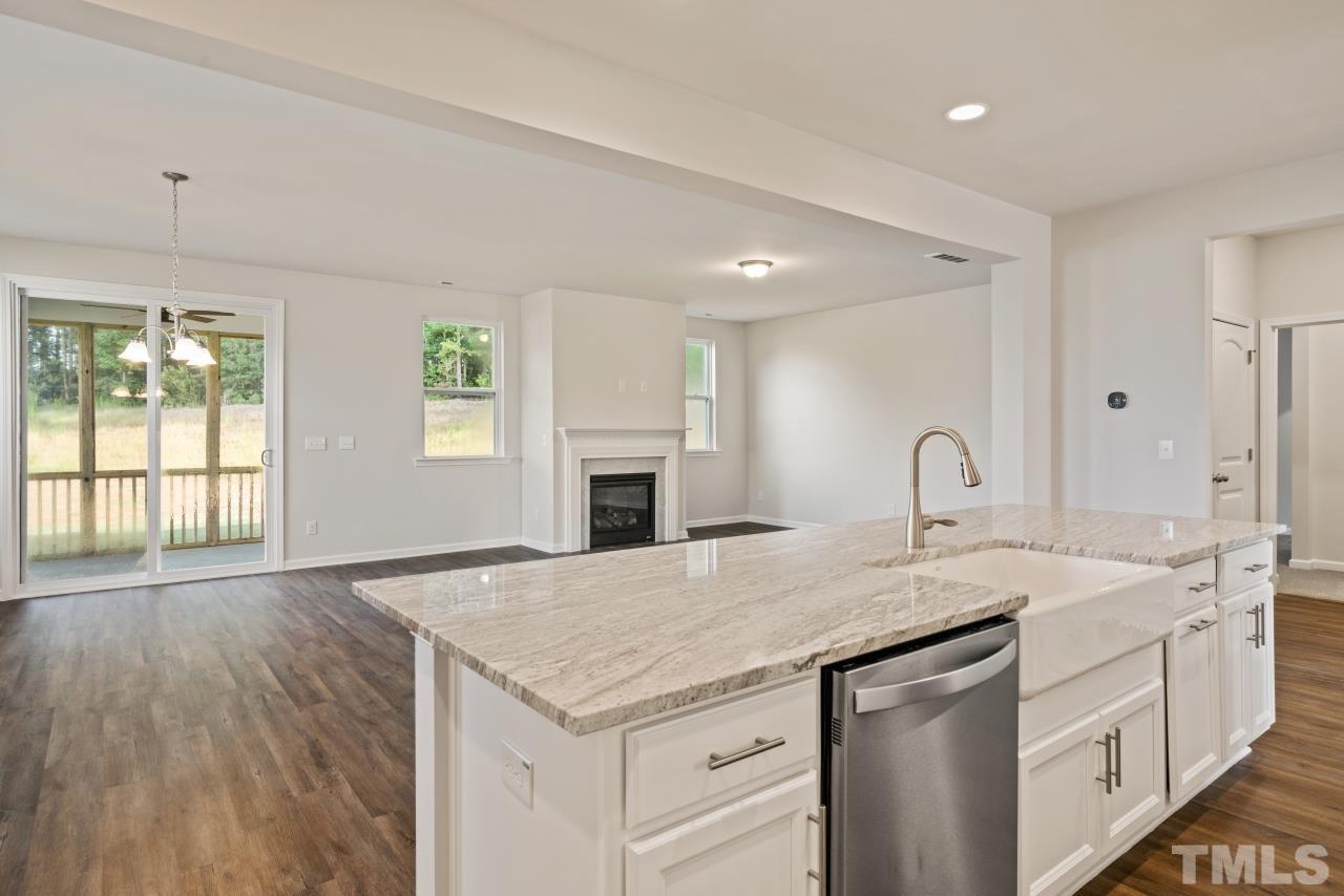 129 Scoville Road Garner, NC 27529 - Photo 17 of 25 a kitchen with a sink a stove cabinets and wooden floor