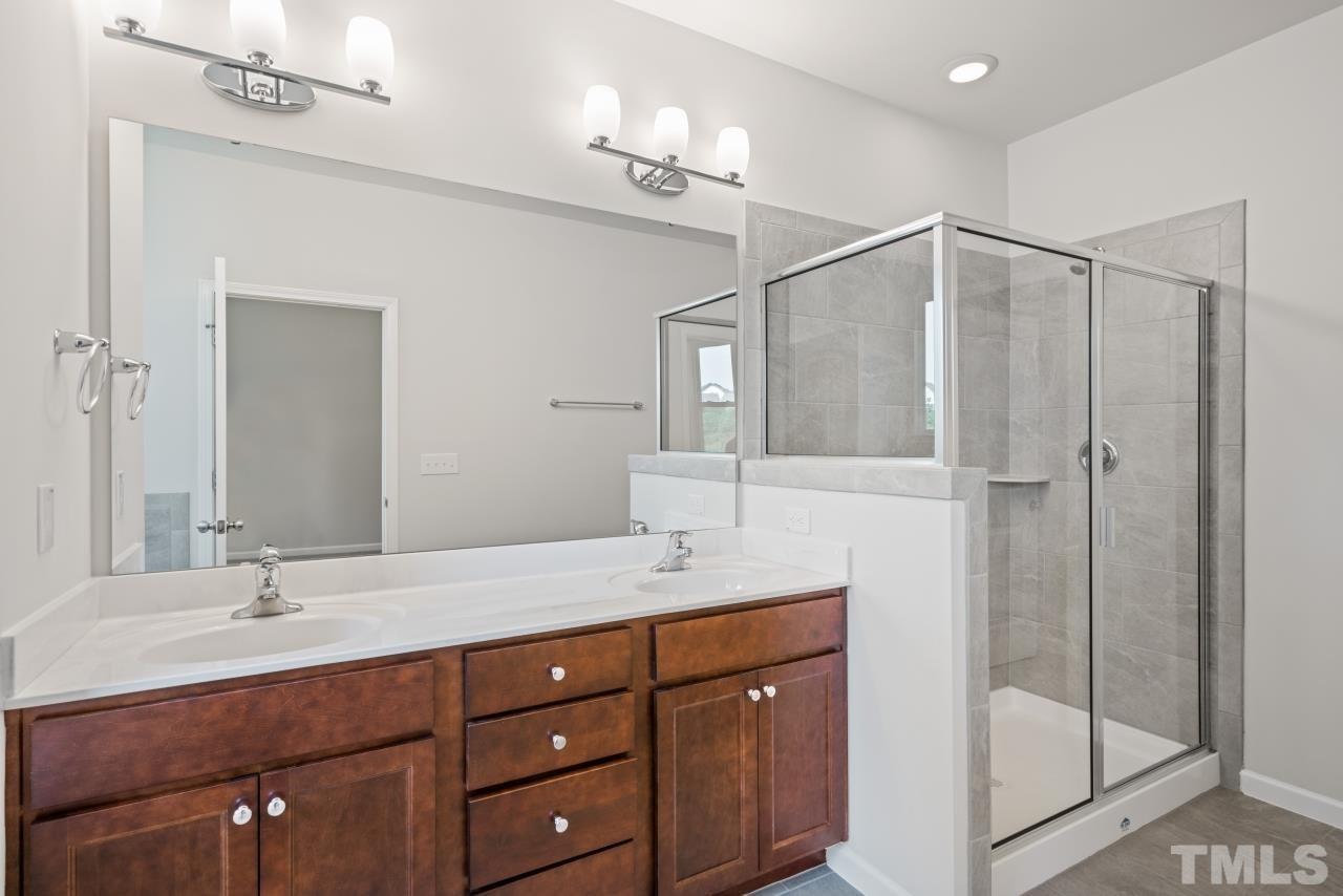 129 Scoville Road Garner, NC 27529 - Photo 21 of 25 a bathroom with a double vanity sink and mirror