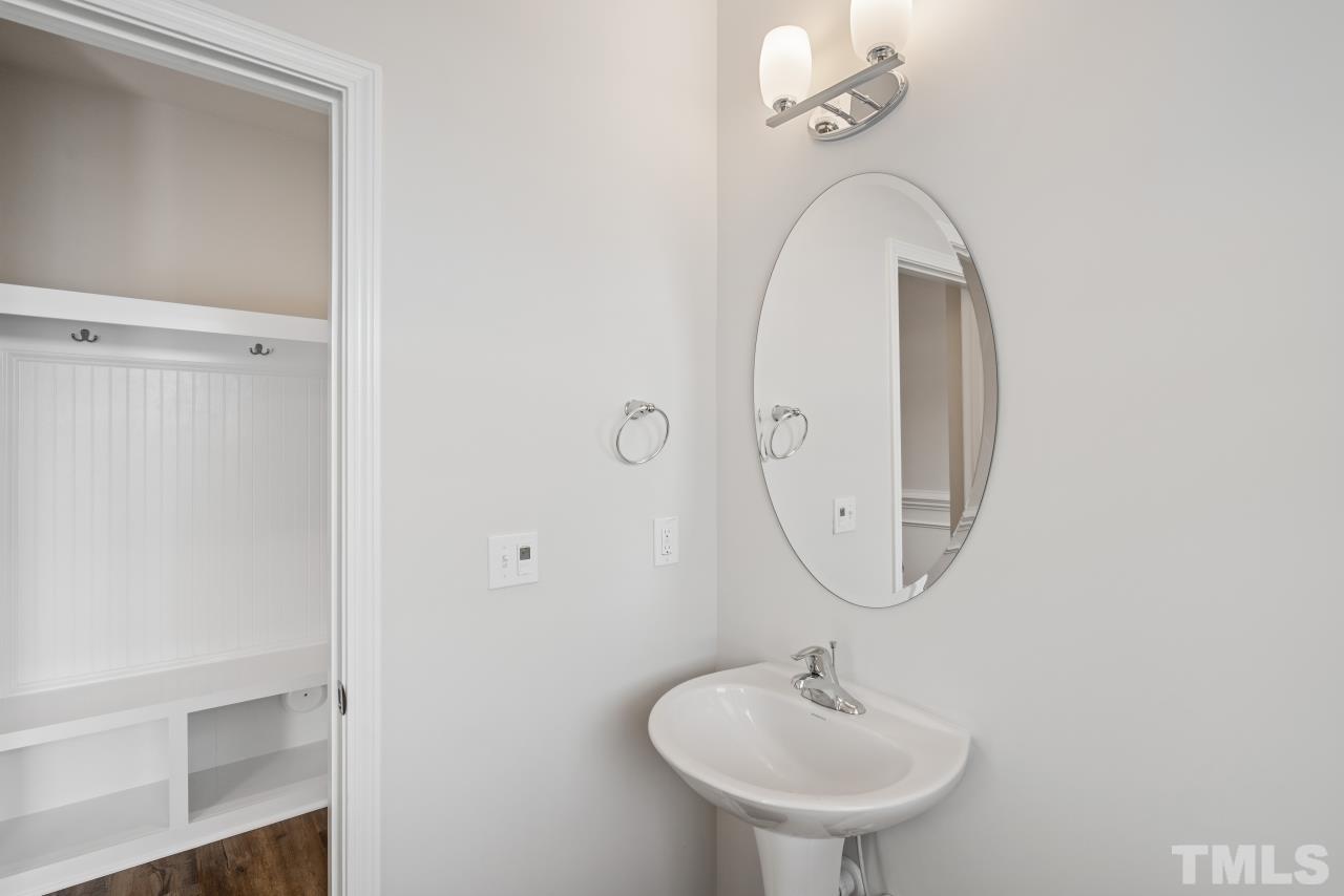129 Scoville Road Garner, NC 27529 - Photo 4 of 25 a bathroom with a sink and a mirror