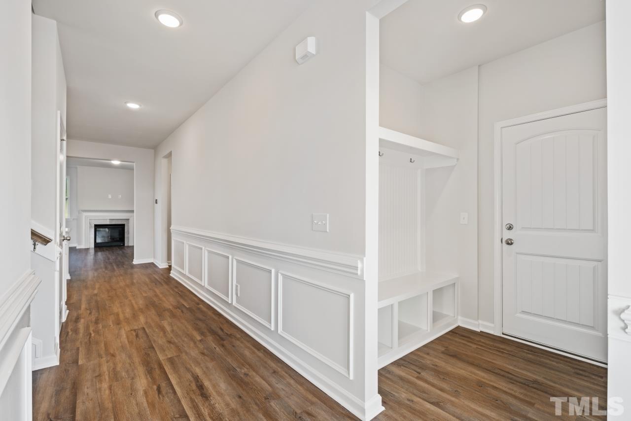 129 Scoville Road Garner, NC 27529 - Photo 7 of 25 a view of a hallway with wooden floor and staircase