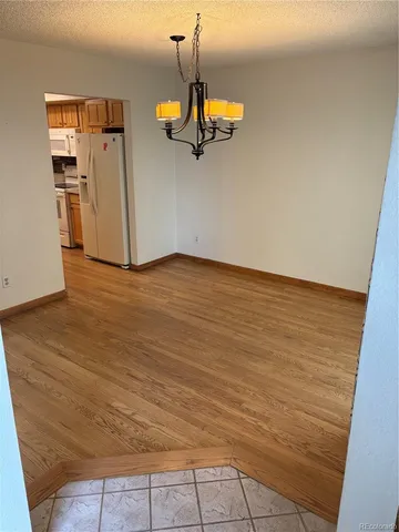 a view of a room with wooden floor