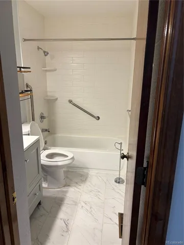 a white toilet sitting next to a bathroom sink