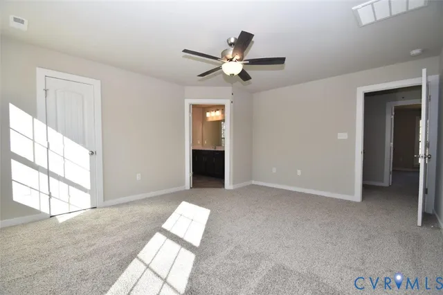 a view of a livingroom with a ceiling fan and window