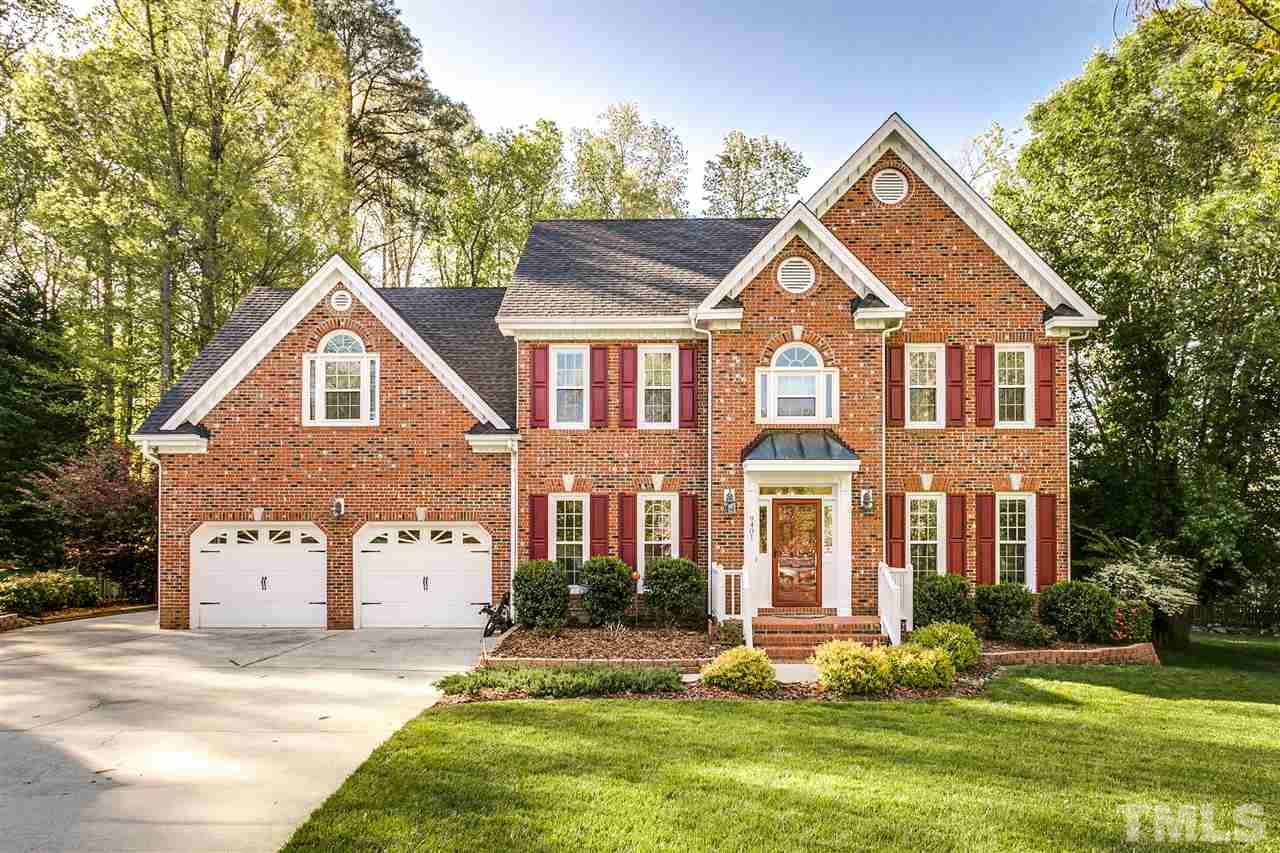 9401 Floral Ridge Court Raleigh, NC 27613 - Photo 1 of 25 a front view of a house with a yard and garage