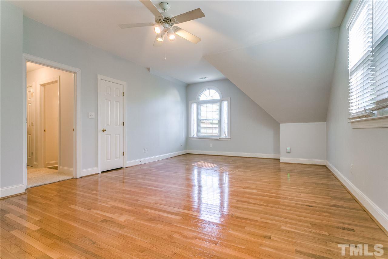 9401 Floral Ridge Court Raleigh, NC 27613 - Photo 11 of 25 a view of an empty room with wooden floor and a window