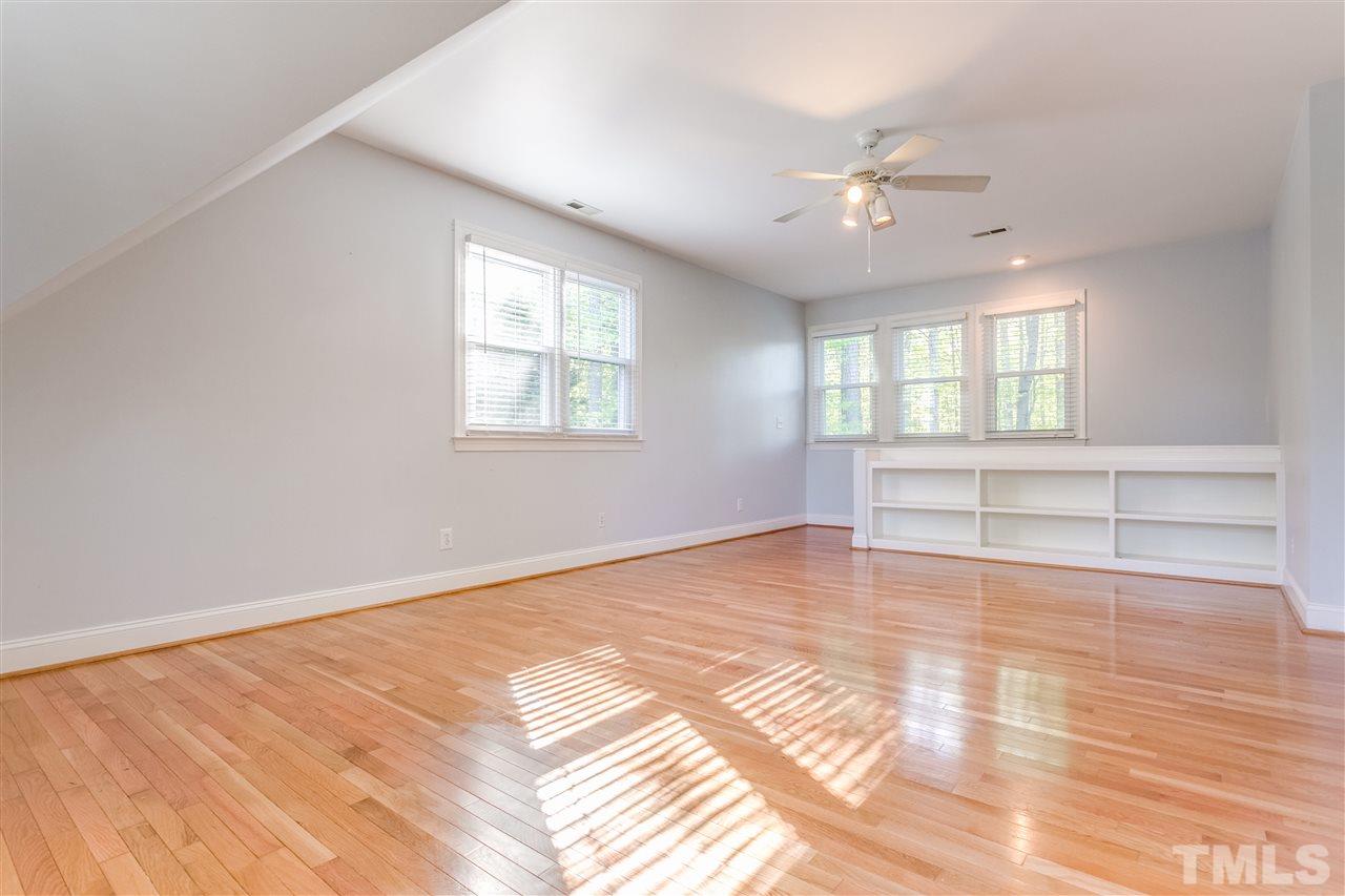 9401 Floral Ridge Court Raleigh, NC 27613 - Photo 12 of 25 an empty room with wooden floor and windows