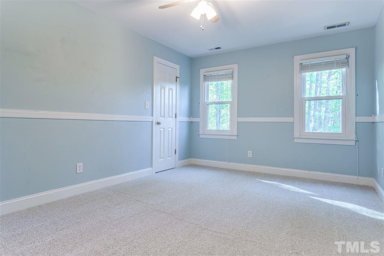 9401 Floral Ridge Court Raleigh, NC 27613 - Photo 13 of 25 an empty room with windows and closet