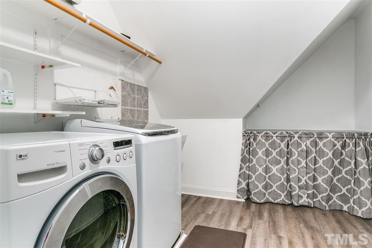 9401 Floral Ridge Court Raleigh, NC 27613 - Photo 15 of 25 a view of washer and dryer with kitchen in the background