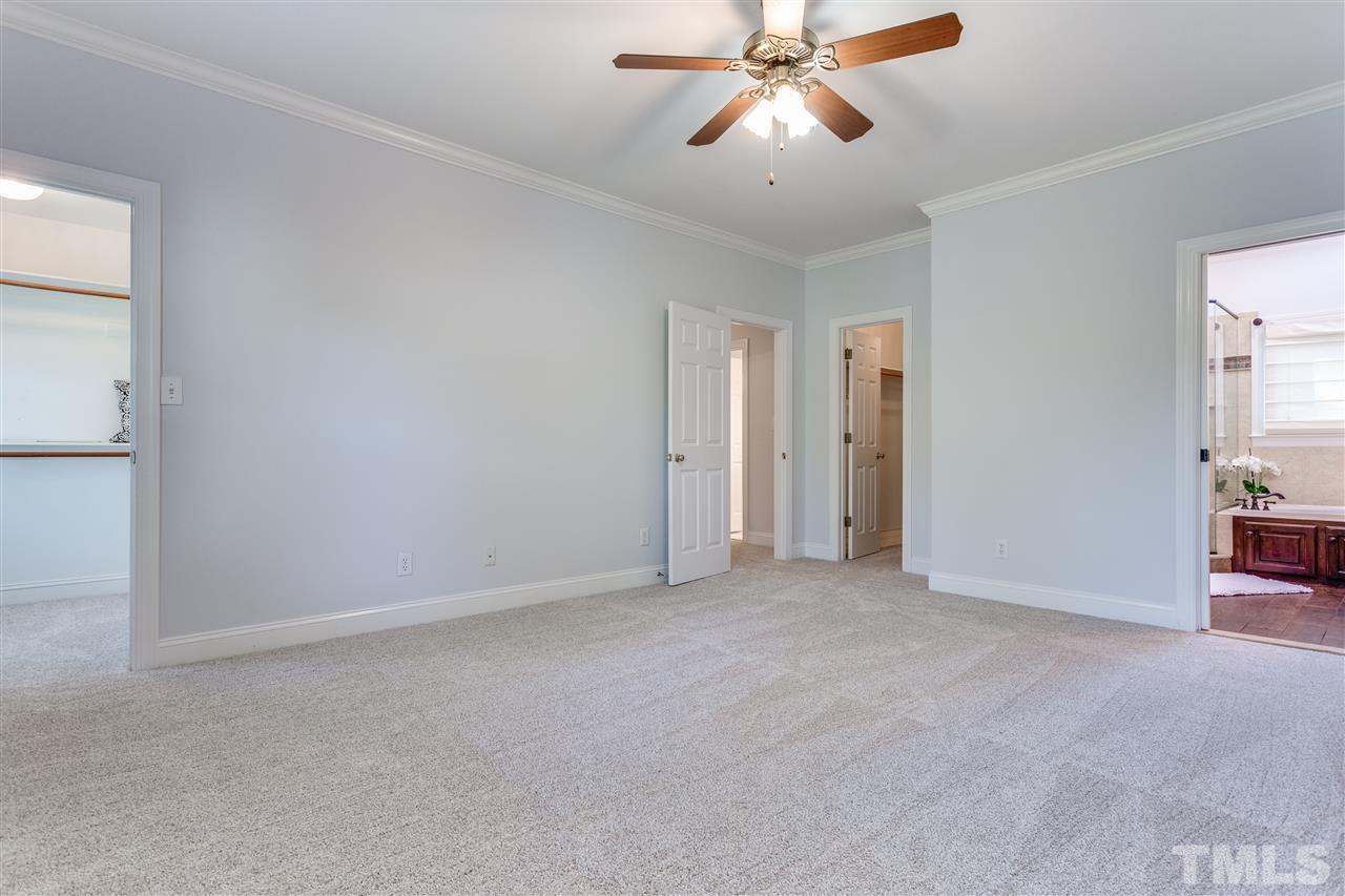 9401 Floral Ridge Court Raleigh, NC 27613 - Photo 16 of 25 an empty room with closet and a chandelier fan
