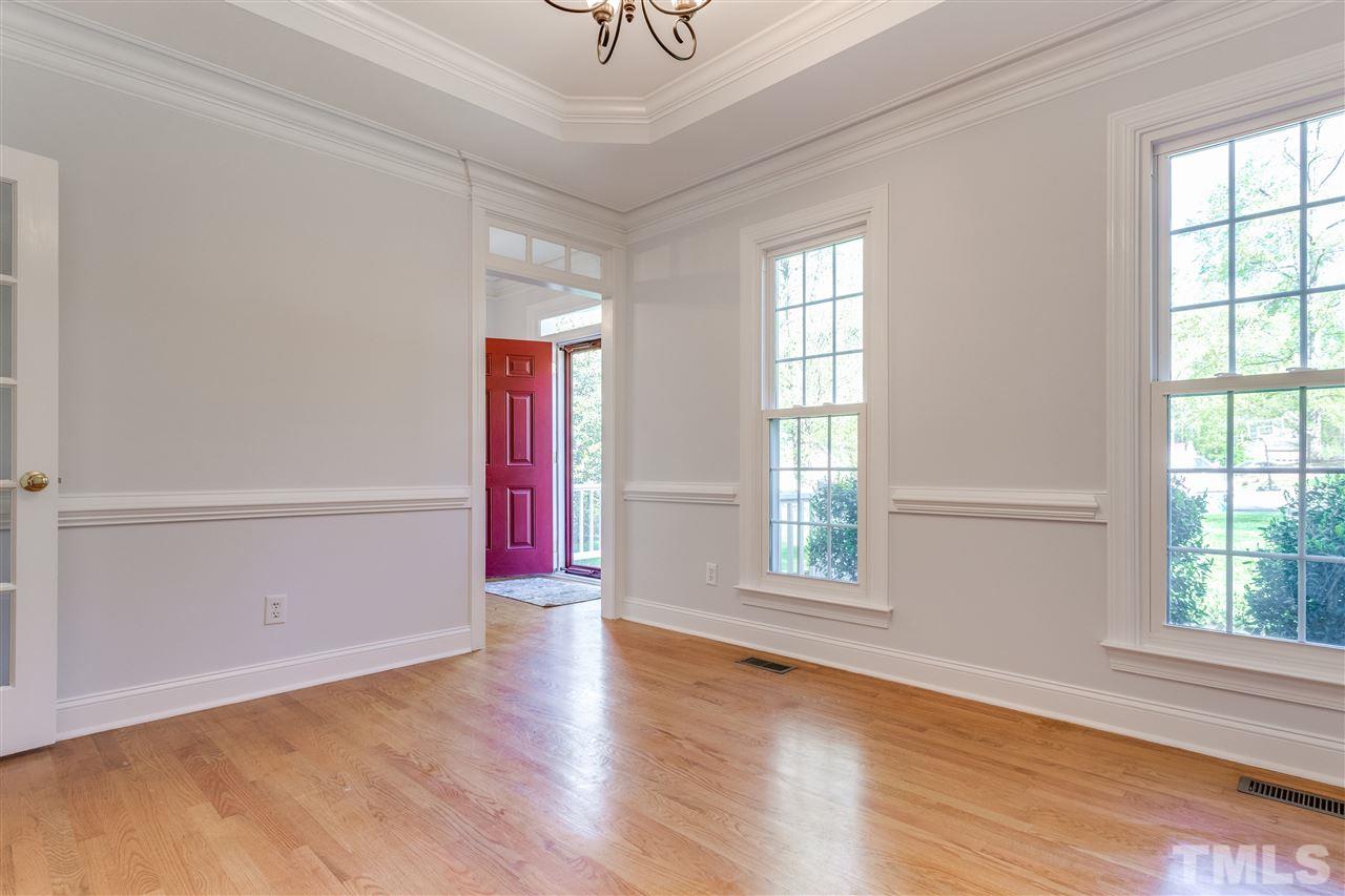 9401 Floral Ridge Court Raleigh, NC 27613 - Photo 5 of 25 an empty room with wooden floor and windows