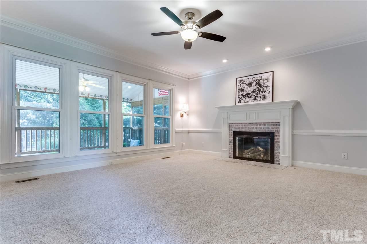 9401 Floral Ridge Court Raleigh, NC 27613 - Photo 7 of 25 a view of an empty room with a fireplace