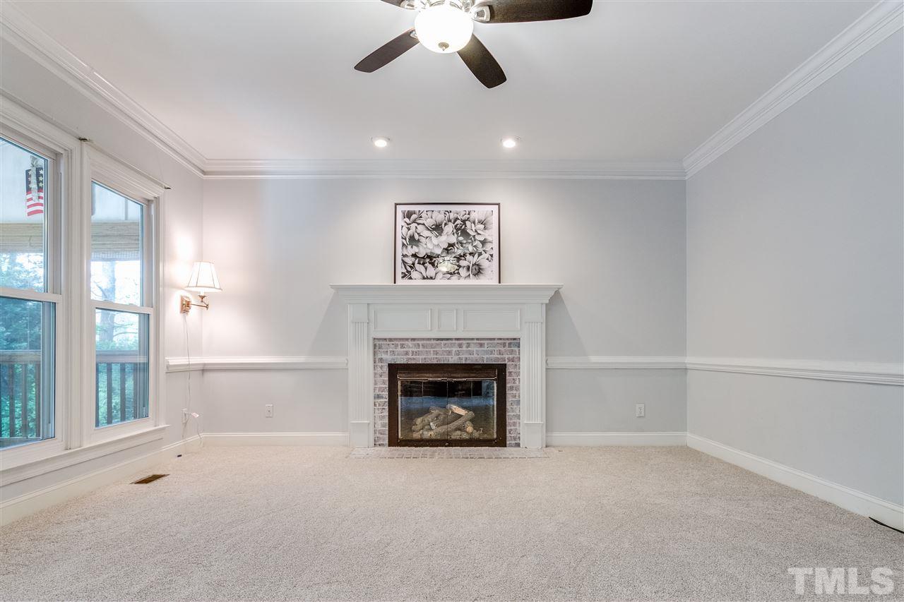 9401 Floral Ridge Court Raleigh, NC 27613 - Photo 8 of 25 a view of an empty room with a fireplace
