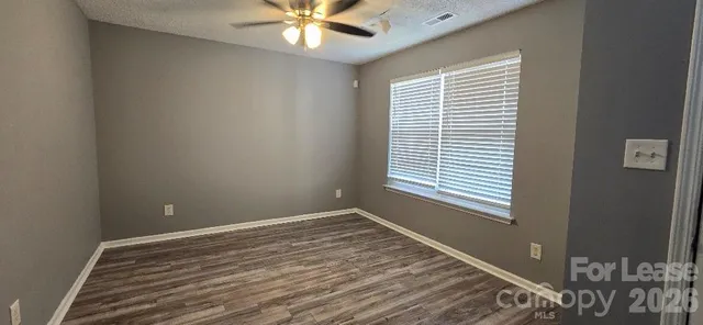 a view of a room with a ceiling fan and a window