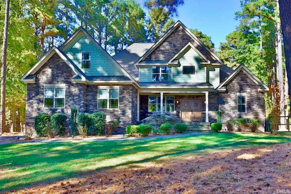 a front view of a house with a yard and porch