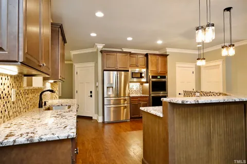 a kitchen with refrigerator and cabinets