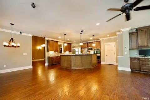 a kitchen with stainless steel appliances granite countertop a refrigerator and a sink