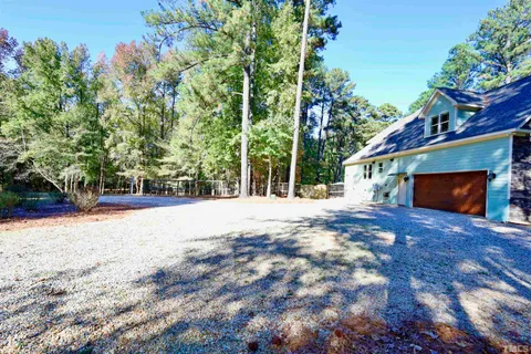 a view of backyard with deck and a garden