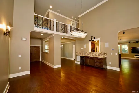 a view of living room with kitchen island stainless steel appliances wooden floor and living room view