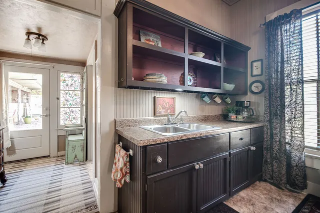 a kitchen with stainless steel appliances granite countertop a sink and wooden cabinets