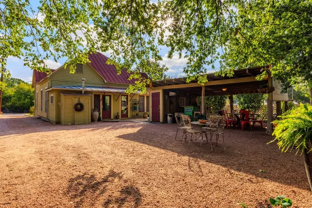 a front view of a house with sitting area and garden