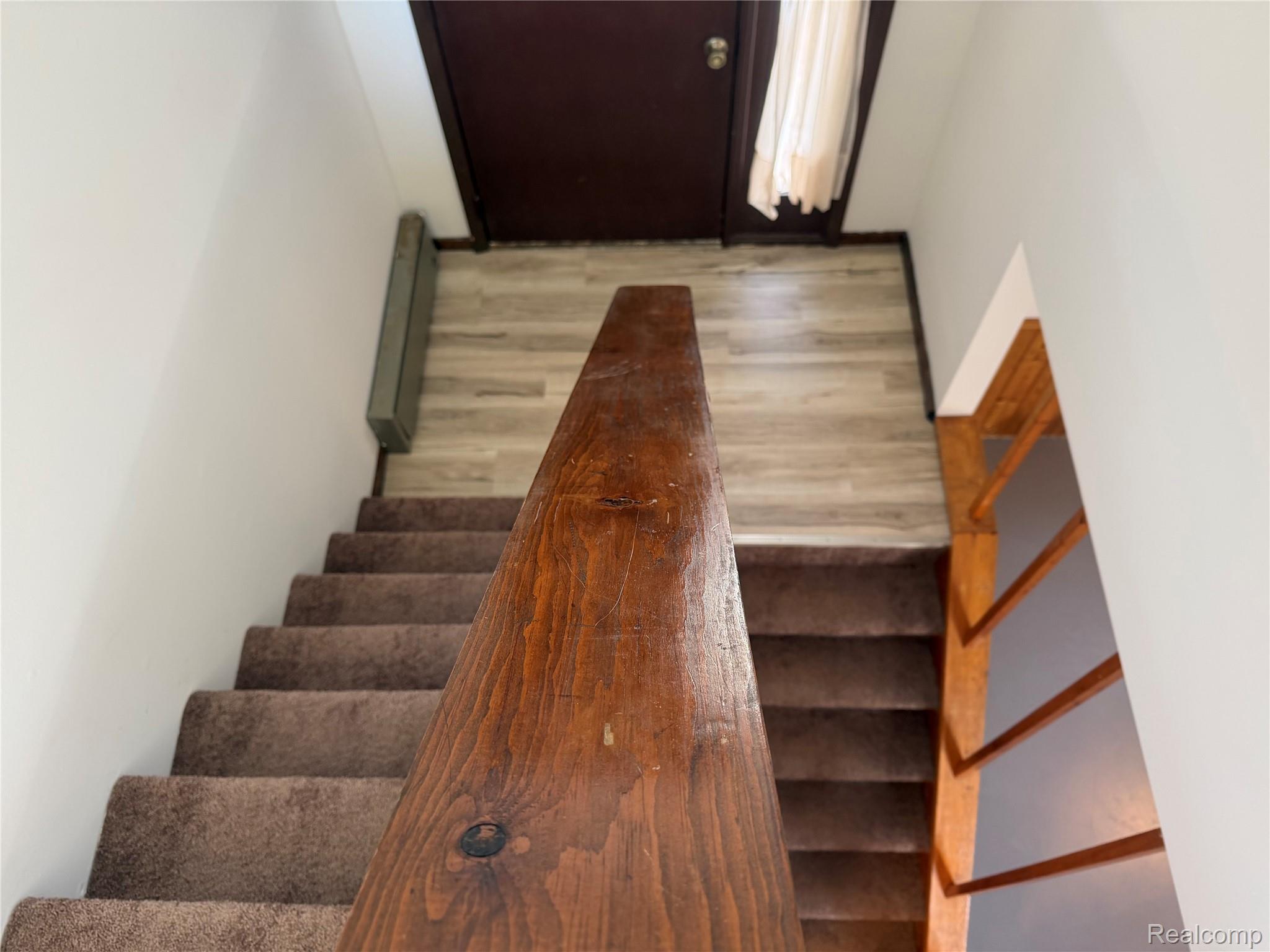 5749 Leix Road Mayville, MI 48744 - Photo 30 of 44 Stairway with wood finished floors and a baseboard heating unit