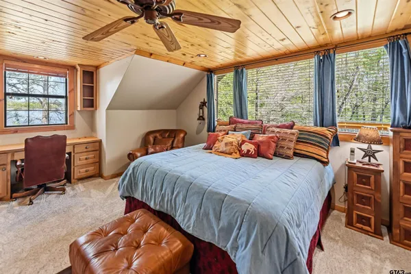 a bathroom with a granite countertop toilet sink and mirror