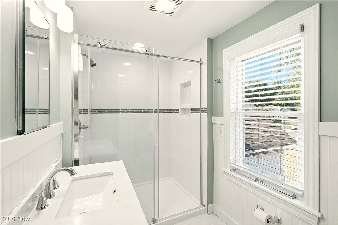 2844 Kent Road Stow, OH 44224 - Photo 29 of 47 Bathroom featuring a stall shower, vanity, and wainscoting