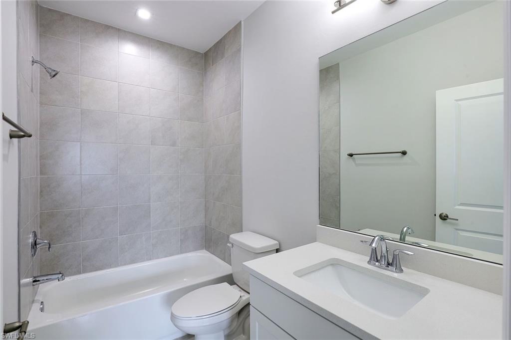 7473 Rockefeller Drive Naples, FL 34119 - Photo 13 of 19 a bathroom with a sink a toilet and shower