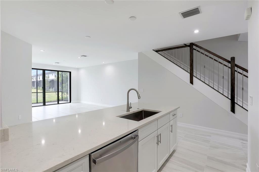 7473 Rockefeller Drive Naples, FL 34119 - Photo 7 of 19 a kitchen with a sink and cabinets