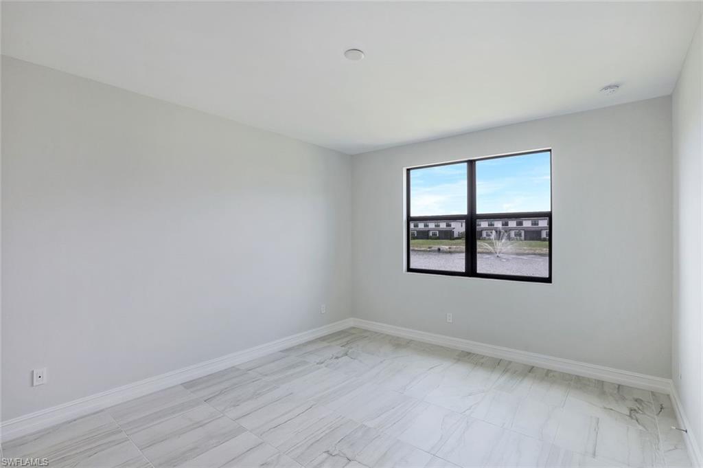 7473 Rockefeller Drive Naples, FL 34119 - Photo 9 of 19 an empty room with a window