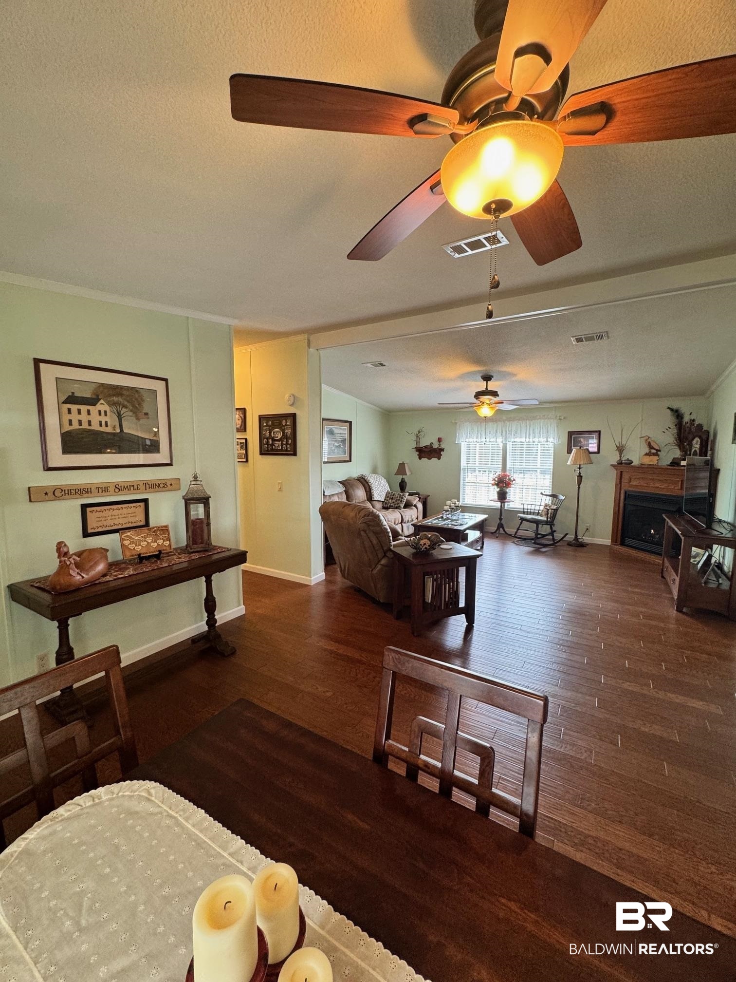 1165 Santa Anna Lane Lillian, AL 36549 - Photo 7 of 43 Living room featuring visible vents, a textured ceiling, and wood finished floors