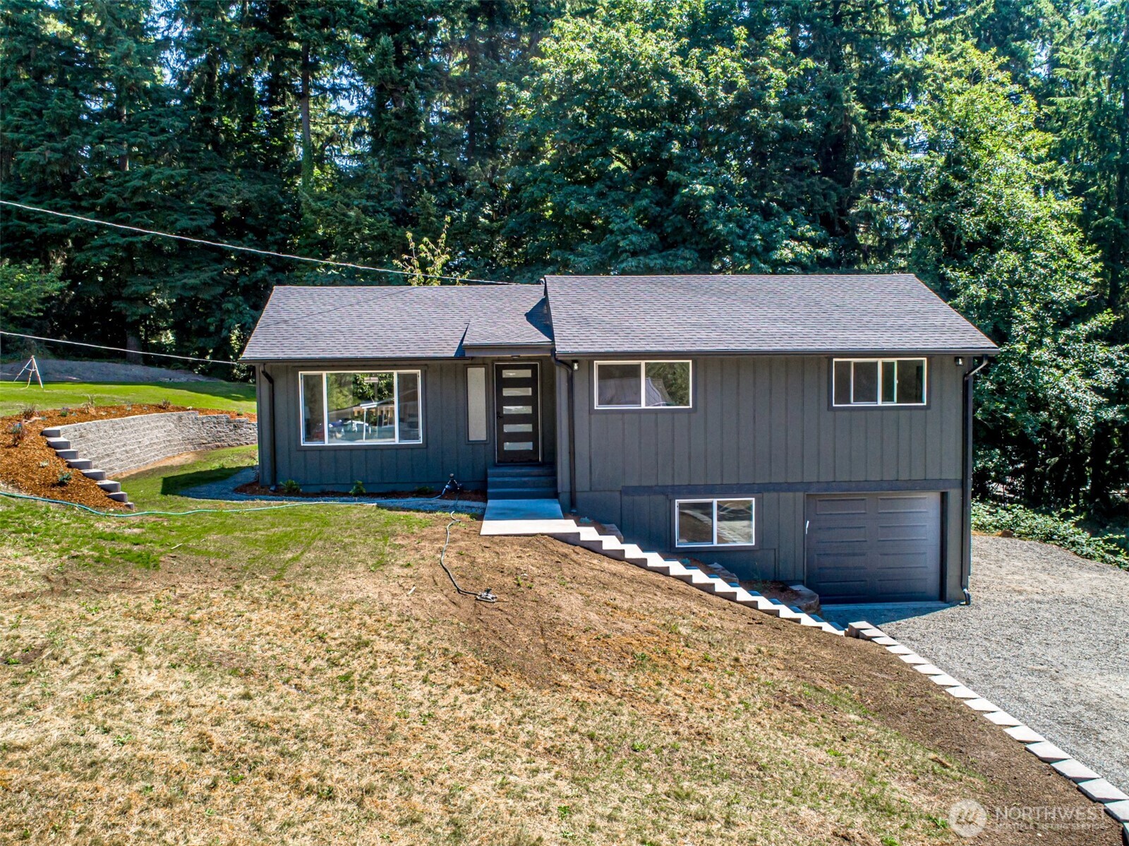 14224 180th Avenue Southeast Renton, WA 98059 - Photo 1 of 26 a front view of a house with a yard and garage