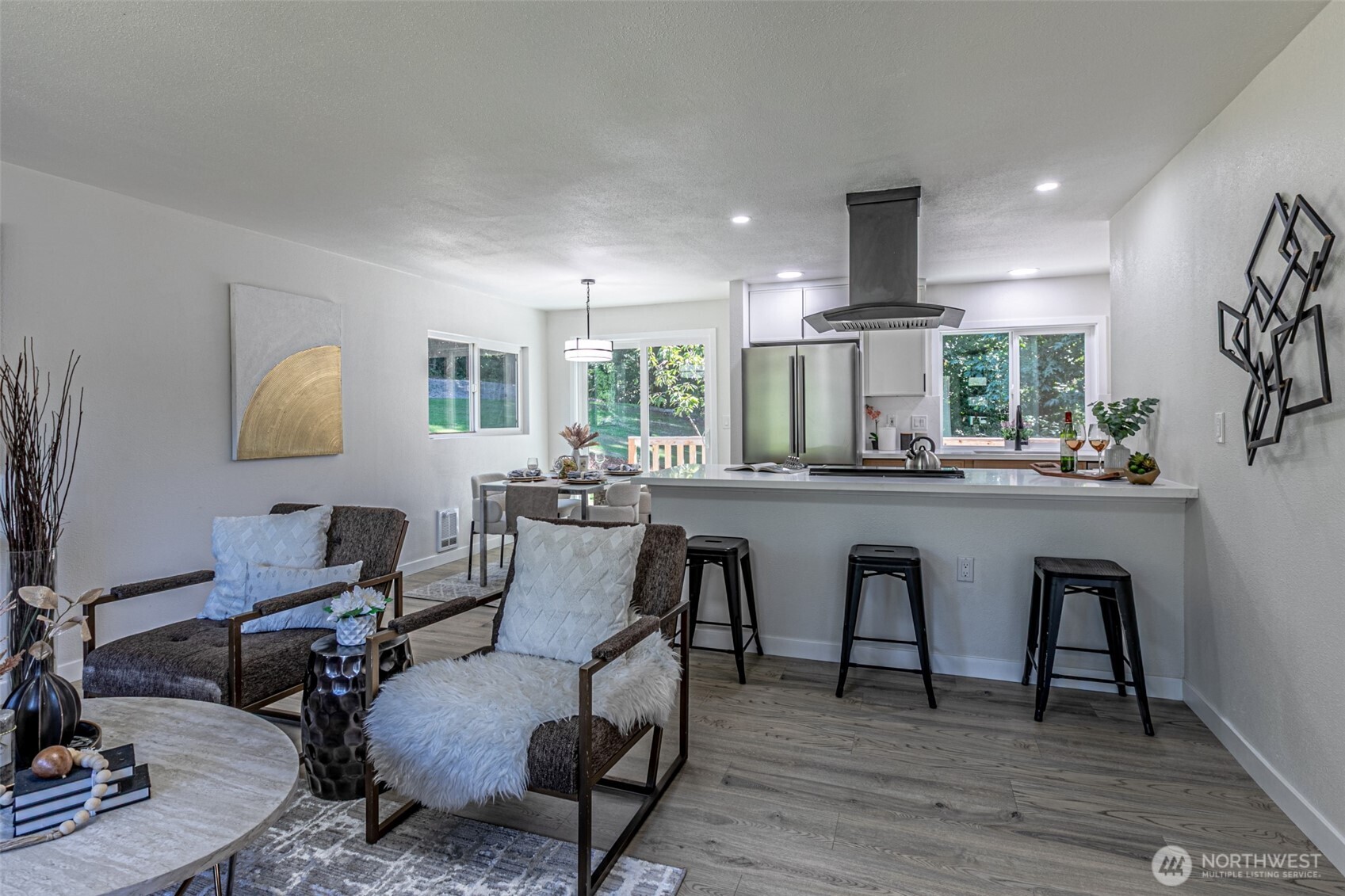 14224 180th Avenue Southeast Renton, WA 98059 - Photo 3 of 26 a living room with furniture a wooden floor and kitchen view