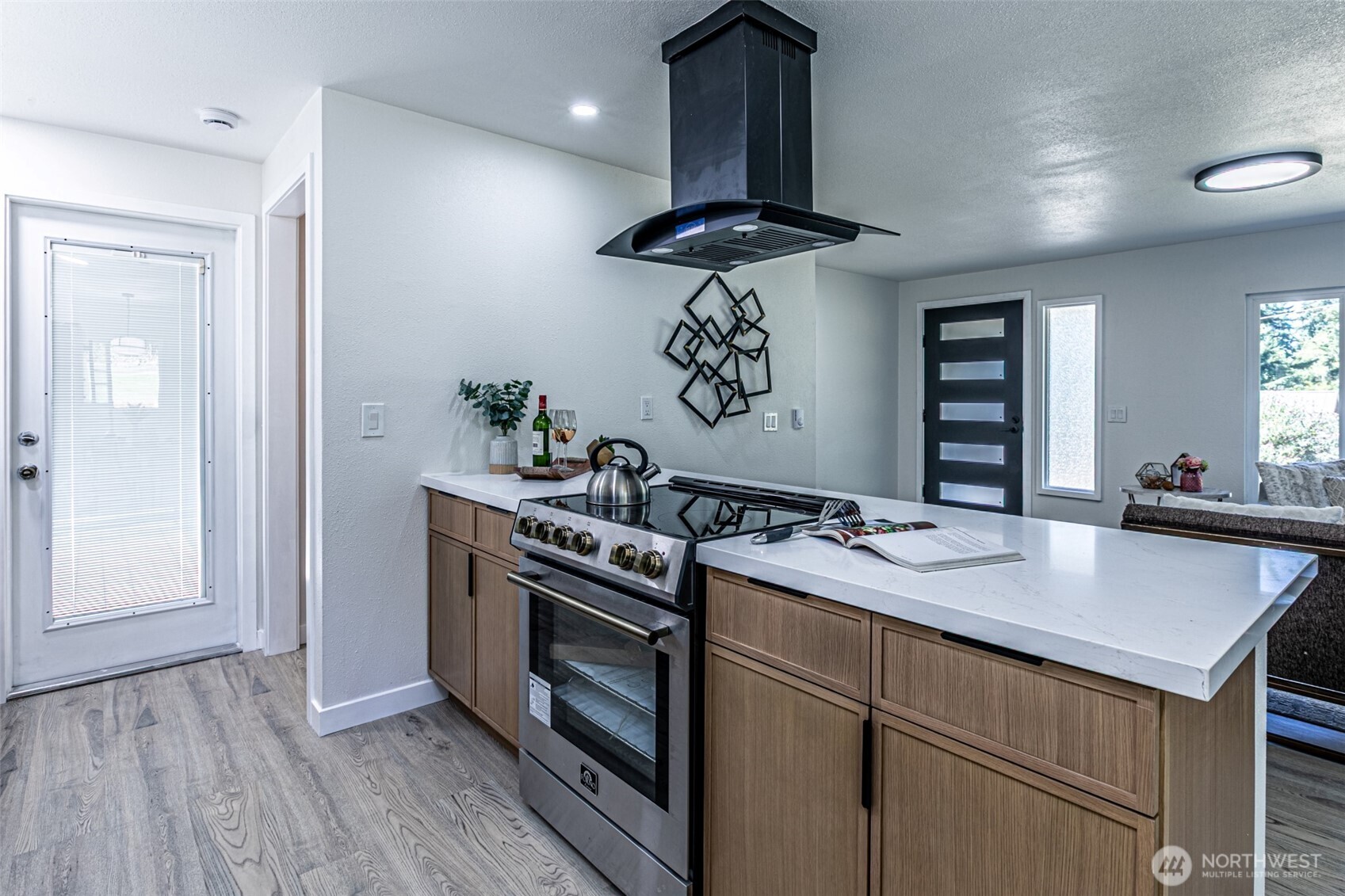 14224 180th Avenue Southeast Renton, WA 98059 - Photo 6 of 26 a kitchen with a stove and a wooden floor