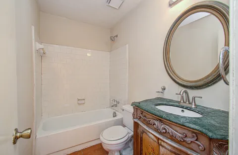 a view of a room with a ceiling fan and a window